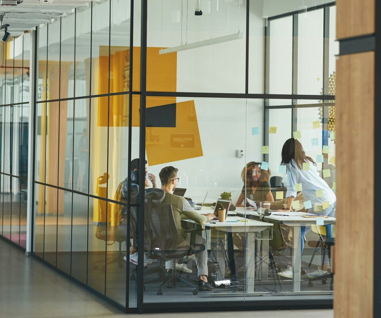 Professional workers discussing issues inside a glass office